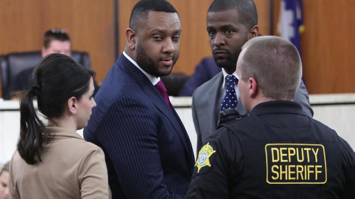 Brian DeQuincey Newman, center, and his attorney Bakari Sellers leave court Tuesday after Newman pleaded guilty to failing to pay state taxes.