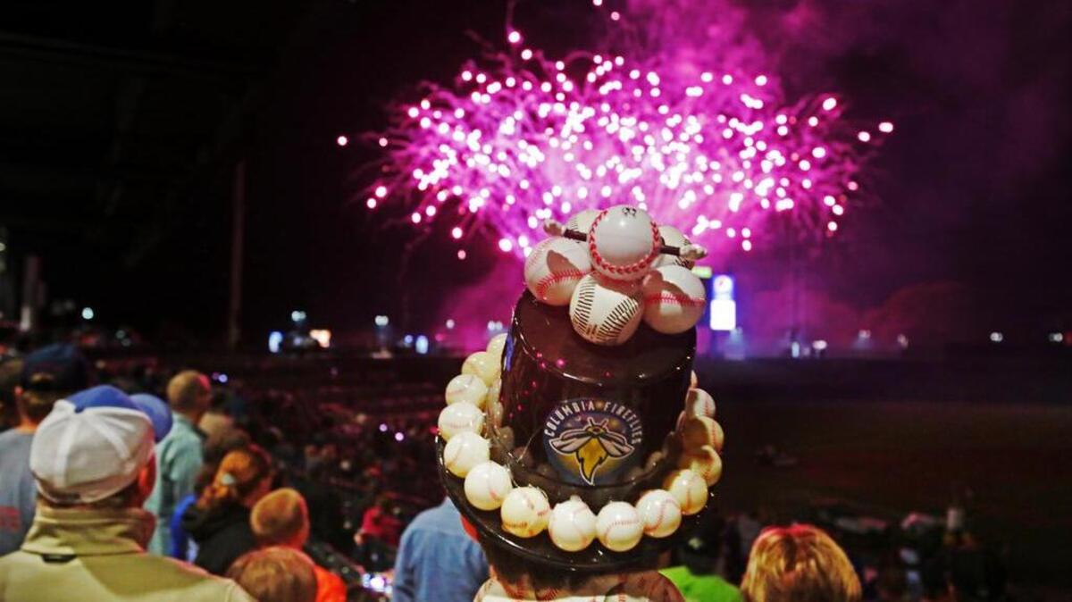 A fan watches the fireworks show at the Columbia Fireflies home opener in mid April.