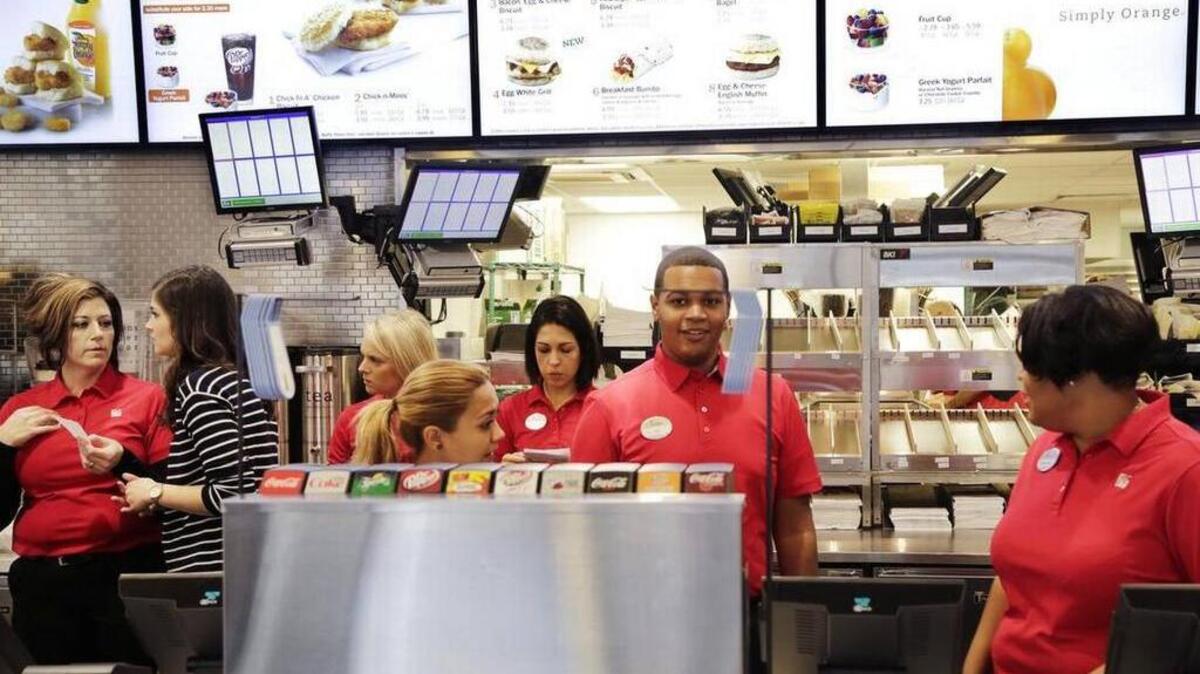 FILE - In this Oct. 1, 2015, file photo, employees familiarize themselves with a new Chick-fil-A restaurant in New York. The restaurant will be giving away free entrees to those wearing cow apparel on Tuesday.