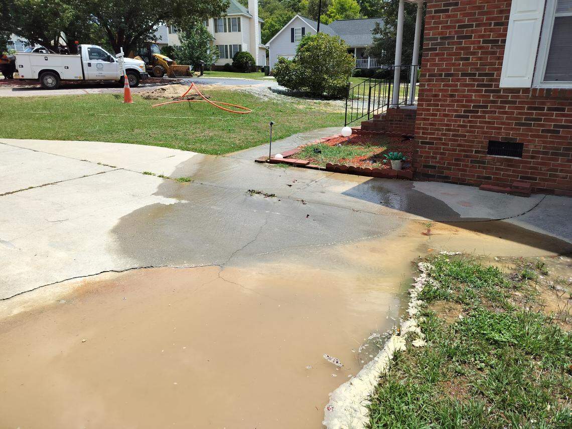 The photo shows a pool of water in a residents driveway after a water main break on Greenglen Drive in the Sandhills area. 