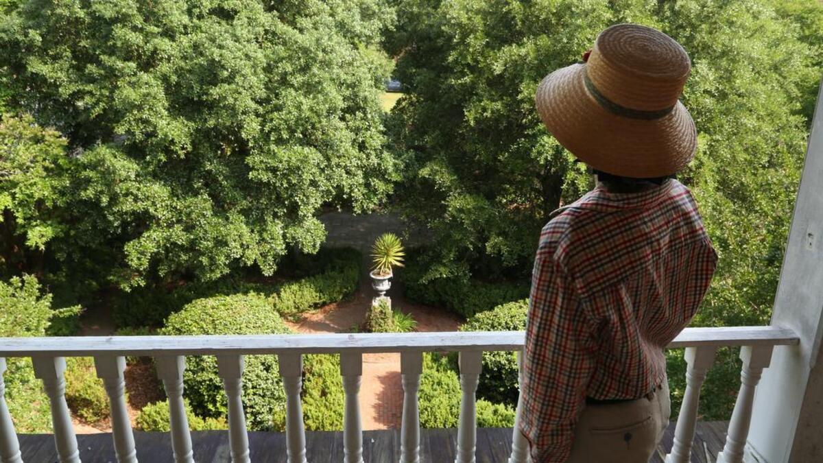 Breedlove looks over the courtyard and garden of her home, the historic De Bruhl-Marshall House in downtown Columbia.