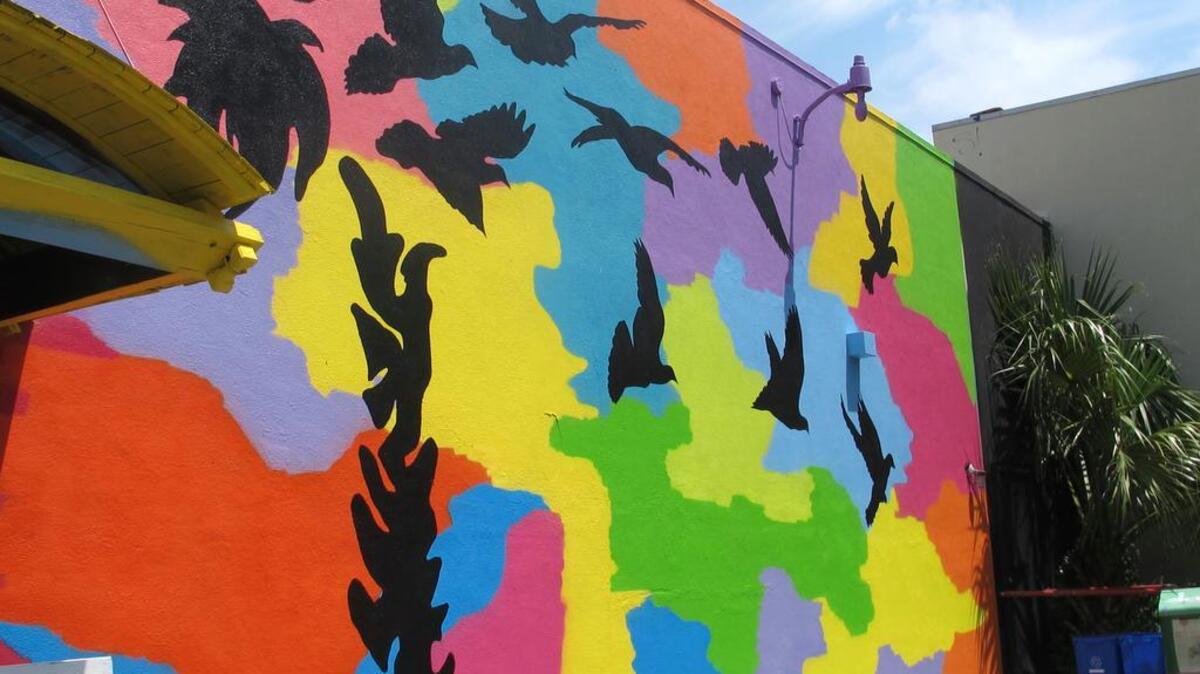 A mural to commemorate the victims of the Emanuel AME Church slayings was unveiled Friday on the side of a building a few blocks from the church. It was created by artist Tripp Derrick Barnes to honor the nine shooting victims as the first anniversary of the attack approaches.