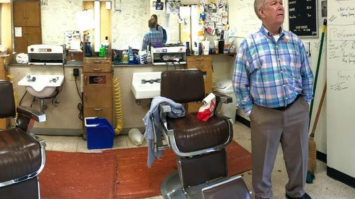 Seen in a panoramic photograph, Joe Tankersly, right, owner of the barbershop on the first floor of The Clemson House, looks out the door near barber Shania Kinard, left, and the many thank you notes written on his walls Thursday afternoon. The barbershop is open through Monday, but then will be closed by the University as The Clemson House is budgeted for demolition.