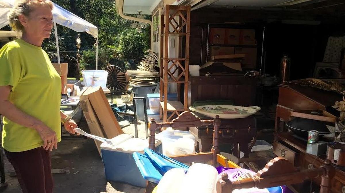 
Janet Enoch surveys possessions in her garage that were pulled from her flooded house.
