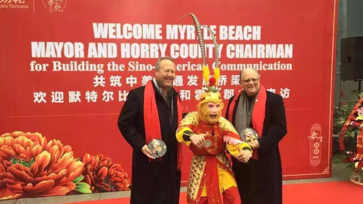 Horry County Council Chairman Mark Lazarus (left) and Myrtle Beach Mayor John Rhodes take part in a ceremony during their recent economic development trip to China.