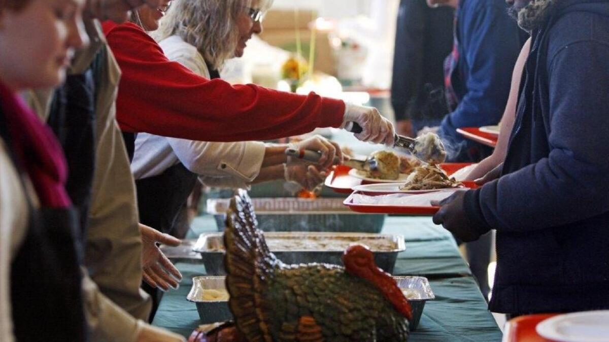 (FILE PHOTO) Volunteers help serve Thanksgiving meals during the 22nd annual Thanksgiving Day dinner hosted by St. Peter's Catholic Church and First Baptist Church of Columbia.