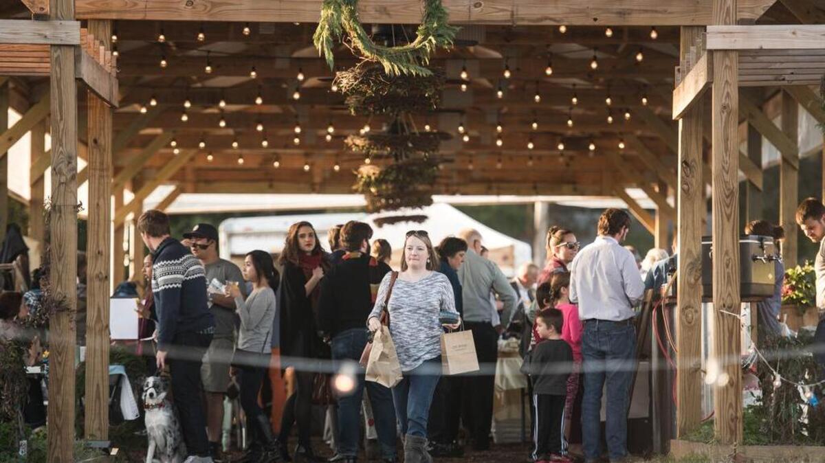Claire Houle heads out of the holiday edition of the City Roots Farmers Market in Columbia. Local vendors sold fresh produce, eggs, milk and gifts made by local artisans.