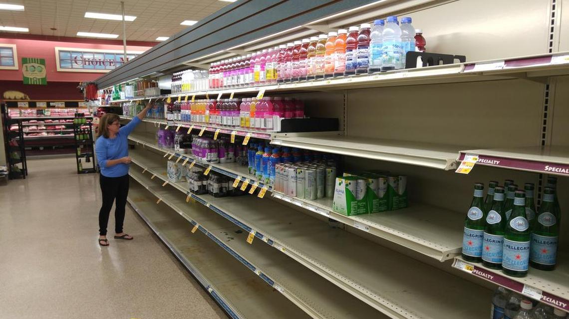 A shopper buys some of the few remaining bottles of water at the Piggly Wiggly store on Devine Street as Hurricane Matthew closed in on South Carolina in October 2016.