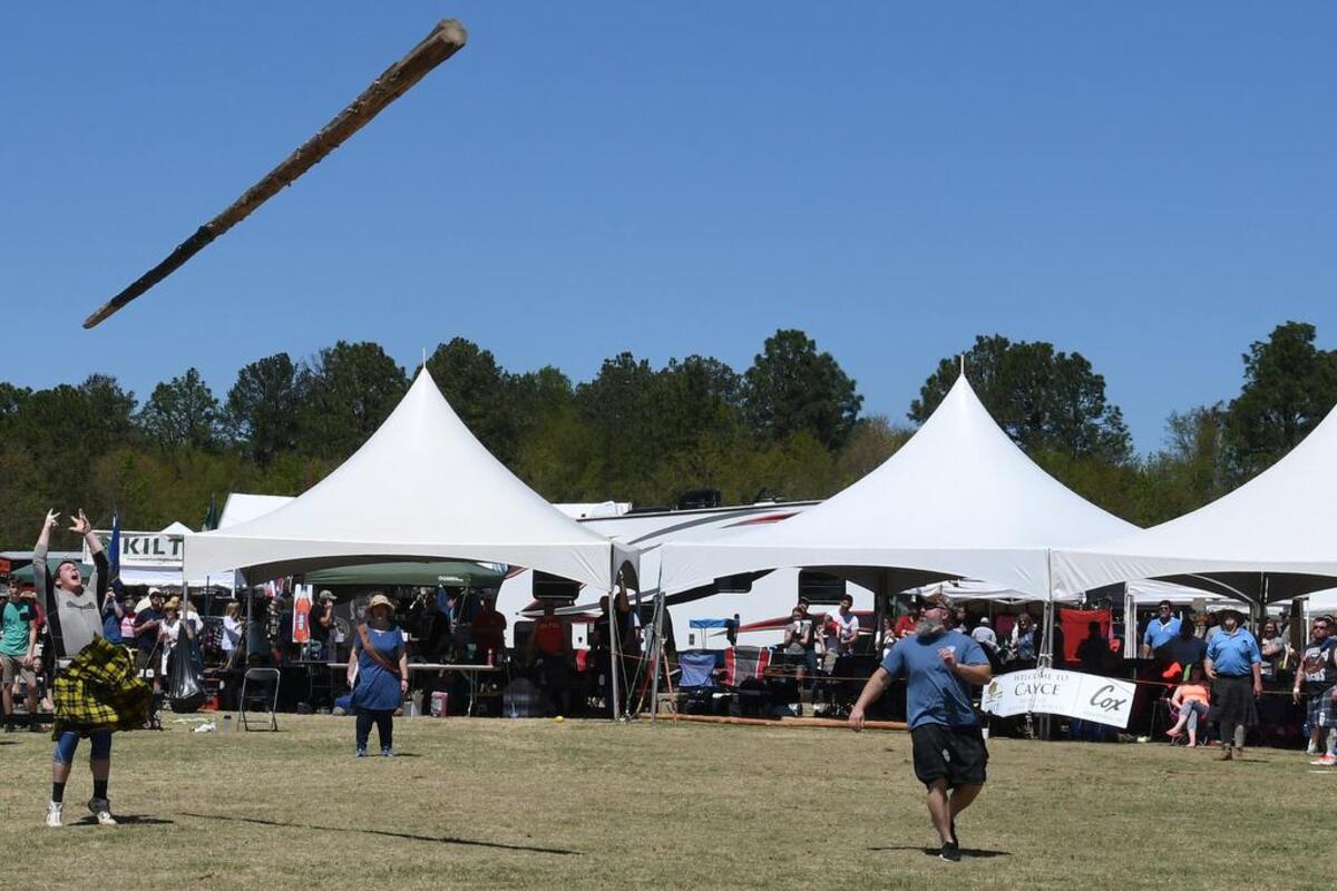 Justin Blatnik of Charlotte throws the caber during the Highland games competition at last year's Tartan Day South. This caber is 20 feet, 6 inches long and weighs 135 pounds. Competitors say it is like throwing a telephone pole end over end.