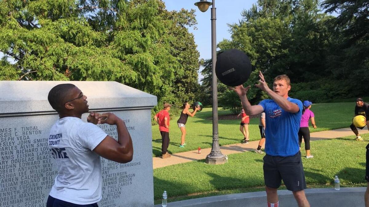 Lexington County firefighters Antoine Kelly (left) and Bryant Smith toss a medicine ball at the State House Monday.