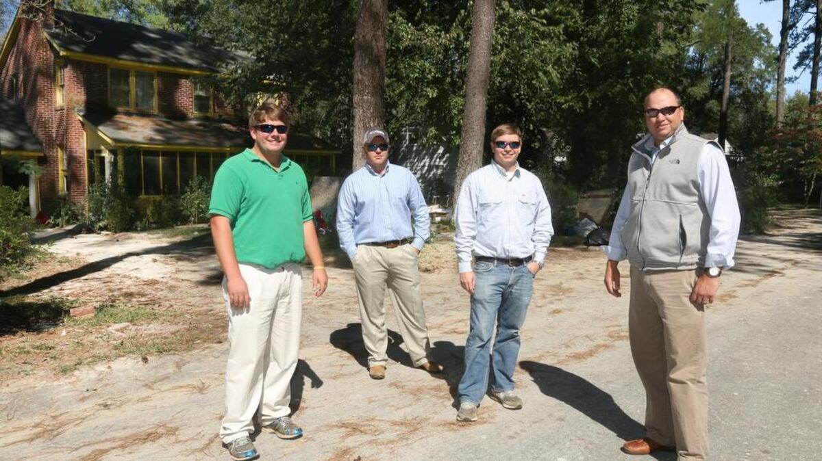 
Frank Roddey, from left, Ryan Truluck, Drew Bozard and Zack Hudson are among those who rescued people by boat along the flooded streets around Lake Katherine in Columbia. They rescued State reporter Jeff Wilkinson, seven other people and four dogs from the second story of the house behind them.
