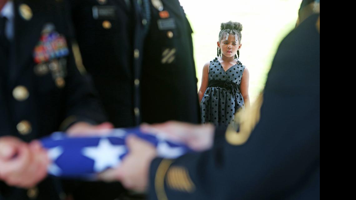 
Members of the Fort Jackson Honor Platoon fold the American Flag draped over the casket of the Rev. Daniel Simmons Sr., during his burial service at Fort Jackson National Cemetery.
