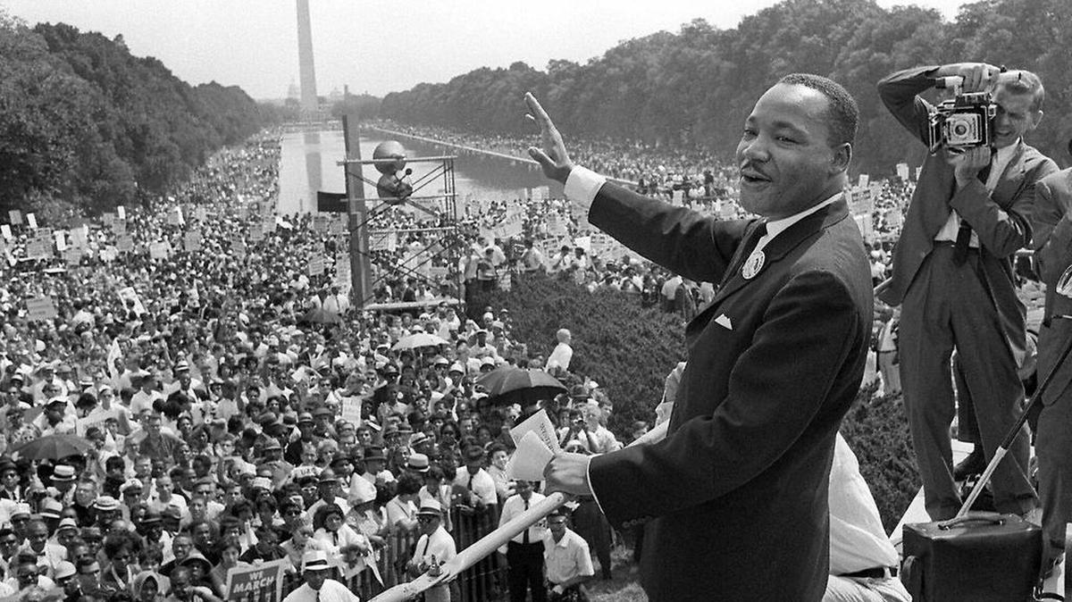 Dr. Martin Luther King, Jr. waves to supporters from the steps of the Lincoln Memorial during the 1963 “March on Washington.” There, he would deliver his famous “I Have a Dream” speech.