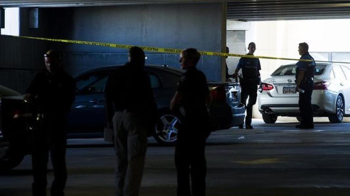 Law enforcement officers investigate the scene of a shooting death on the third floor of a parking garage in Greenville on July 13, 2017.
