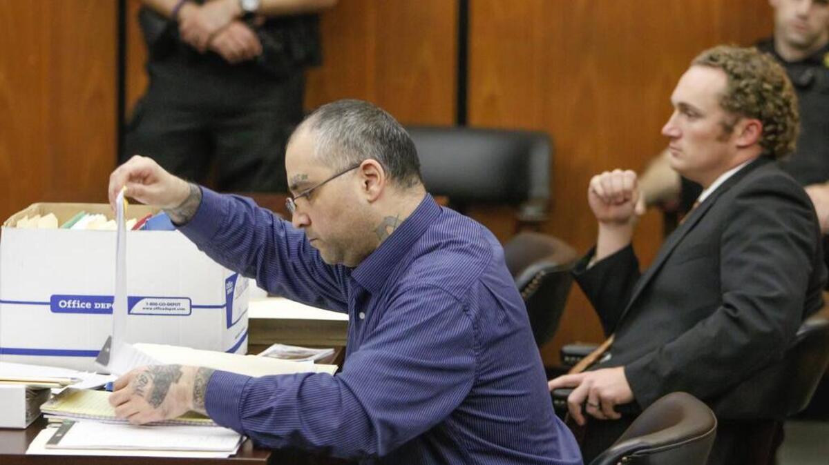 Accused home invader Nathan Martinez leafs through paperwork as he questions witnesses while representing himself in his trial in Richland County Court on Nov. 29, 2016. Justin Kata, his court-appointed stand-by attorney is seated next to him, but may only help Martinez if asked. Martinez faces various rape, burglary, robbery and kidnapping charges.