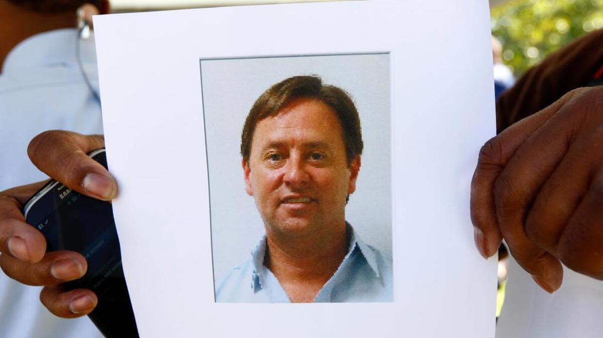 
Investigators are searching for Shannon Lamb, displayed in a digital photograph released by the Mississippi Department of Public Safety investigators to members of the media and held by a reporter, who they now consider a suspect in the death of Delta State University history professor Ethan Schmidt, Monday, Sept. 14, 2015, at the Cleveland, Miss., campus. AP Photo/Rogelio V. Solis)
