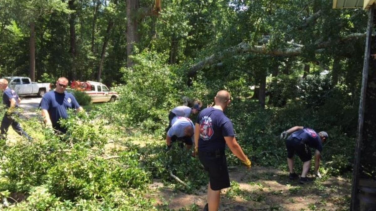 Lugoff crews help a homeowner on Park Drive in Lugoff remove storm debris after a tree fell on the resident’s roof and pick-up truck.