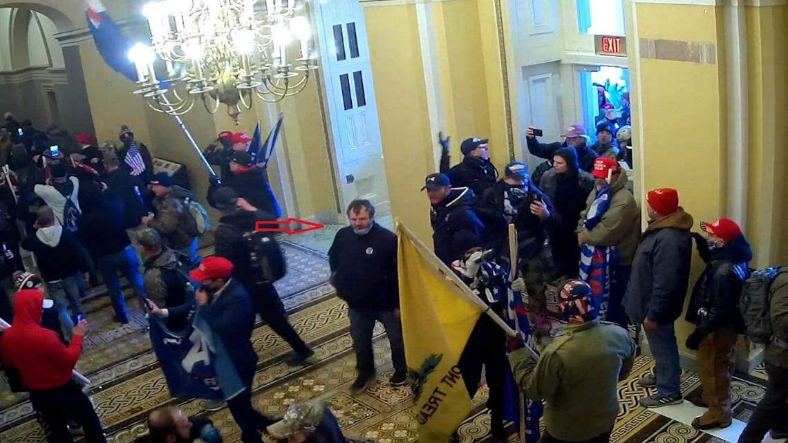 George Tenney III, in center of photo and wearing a black jacket, was captured by surveillance cameras at 2:19 p.m. on Jan. 6. He is standing inside the Senate wing of the Capitol, minutes after the mob broke into the building.