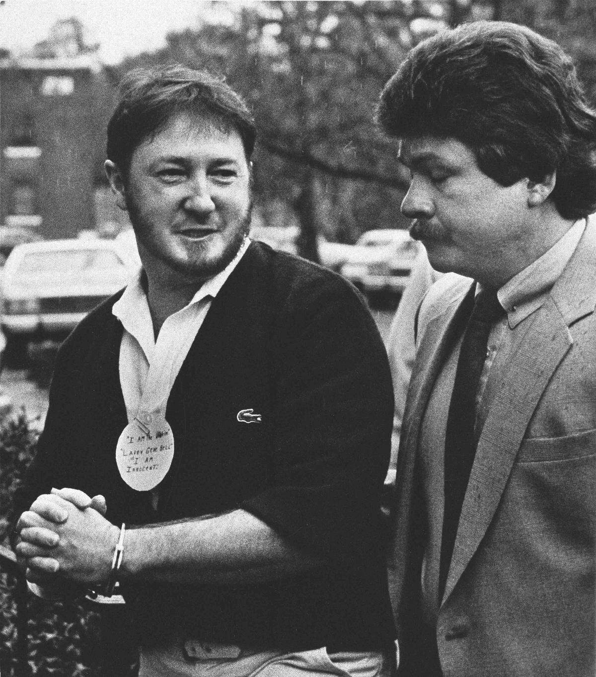 Larry Gene Bell, left, arrives at the Berkeley County courthouse on Feb.11, 1986, where jury selection began in his trial on charges of murder and kidnapping in the slaying Shari Faye Smith. Bell wore a circular paper clipped to his shirt that read, “I am the victim Larry Gene Bell . I am innocent.”