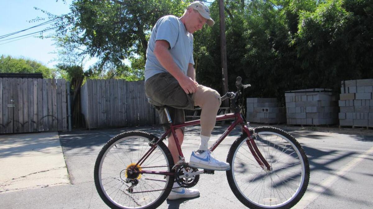 
James Blanks, 52, who has a prosthetic leg and is voiceless, riding a borrowed bicycle after his was stolen in Rock Hill when he was at a charity getting food. 
