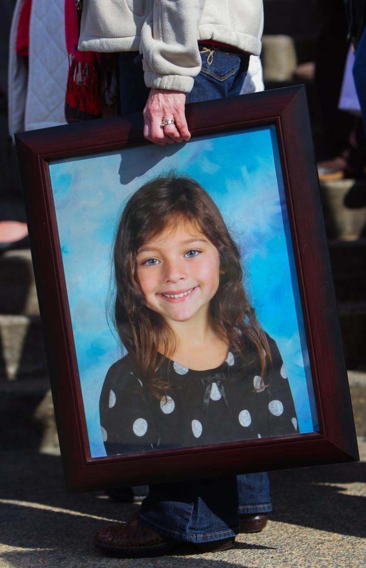 A supporter holds a photograph of Emma Longstreet during a 2014 lobbying effort to convince the Legislature to pass Emma’s Law.