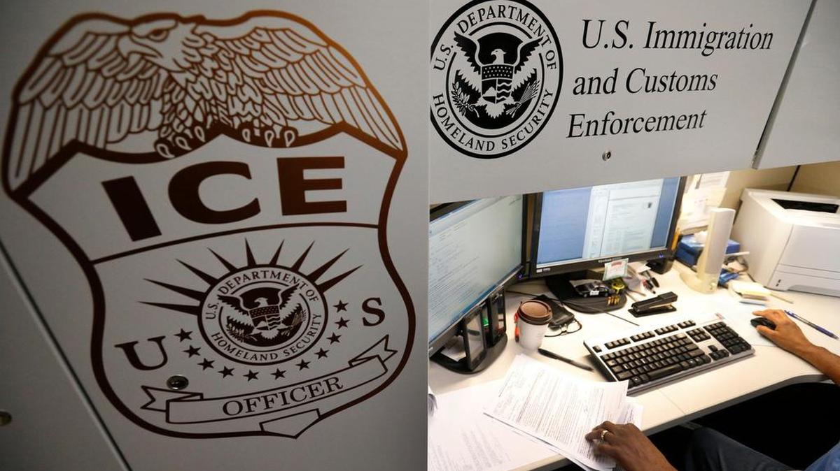 An unidentified U.S. Immigration and Customs Enforcement deportation officer reviews forms.