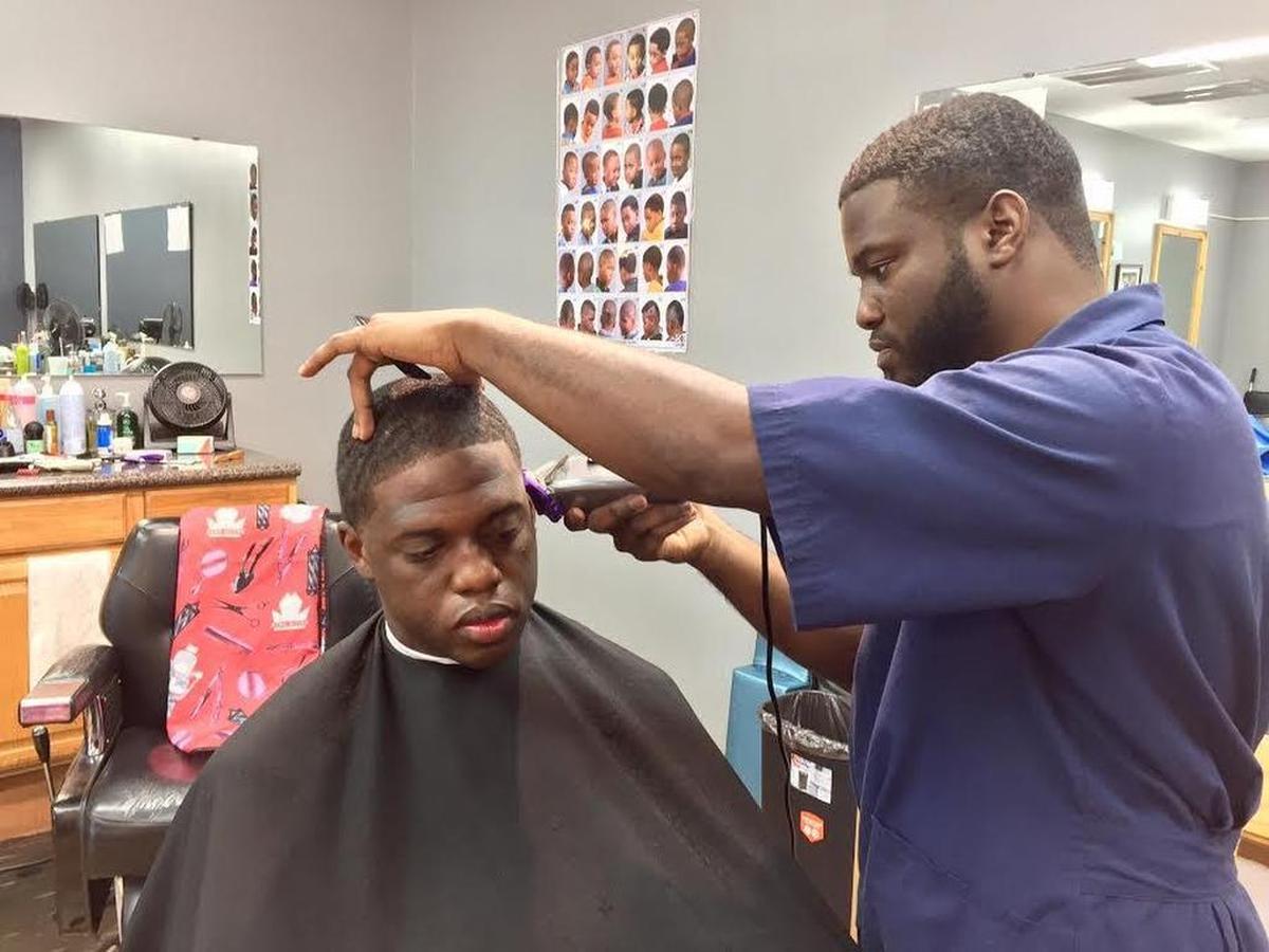 Corey Tucker gives a shave to Keith Stokes at Toliver’s Mane Event on North Main Street. The barber shop is one of several to whom the Richland County Sheriff’s Department has offered free concealed-weapons permit training in the year since a robbery attempt at a Columbia barber shop was thwarted by a permit-carrying barber and patron.