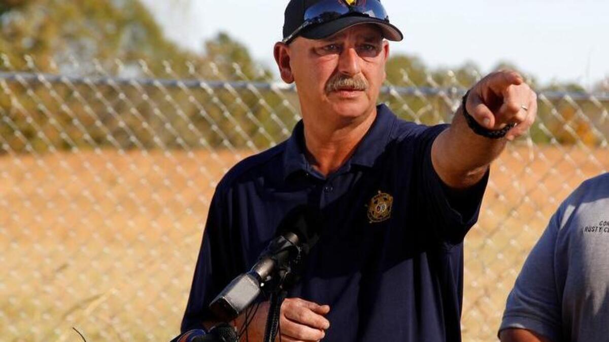 Ex- Spartanburg County Sheriff Chuck Wright, who will be sentenced for criminal acts Tuesday, and Coroner Rusty Clevenger talk to the media in 2016 outside Todd Kohlhepp's property on Wofford Road in Woodruff, S.C.