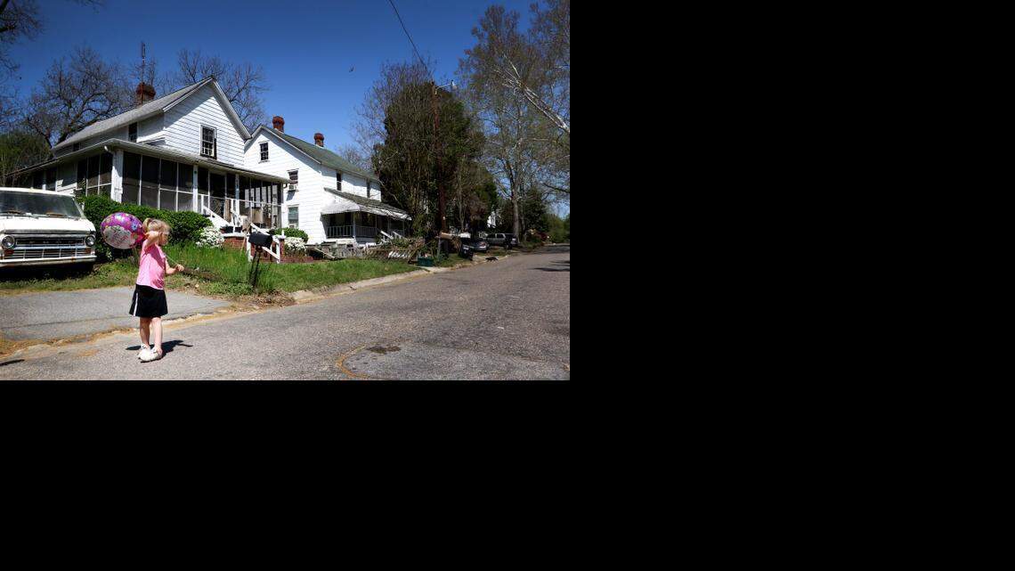 
Brandi Moore strolls outside of the home where 51-year-old William Kernan shot a police officer Tuesday afternoon.
