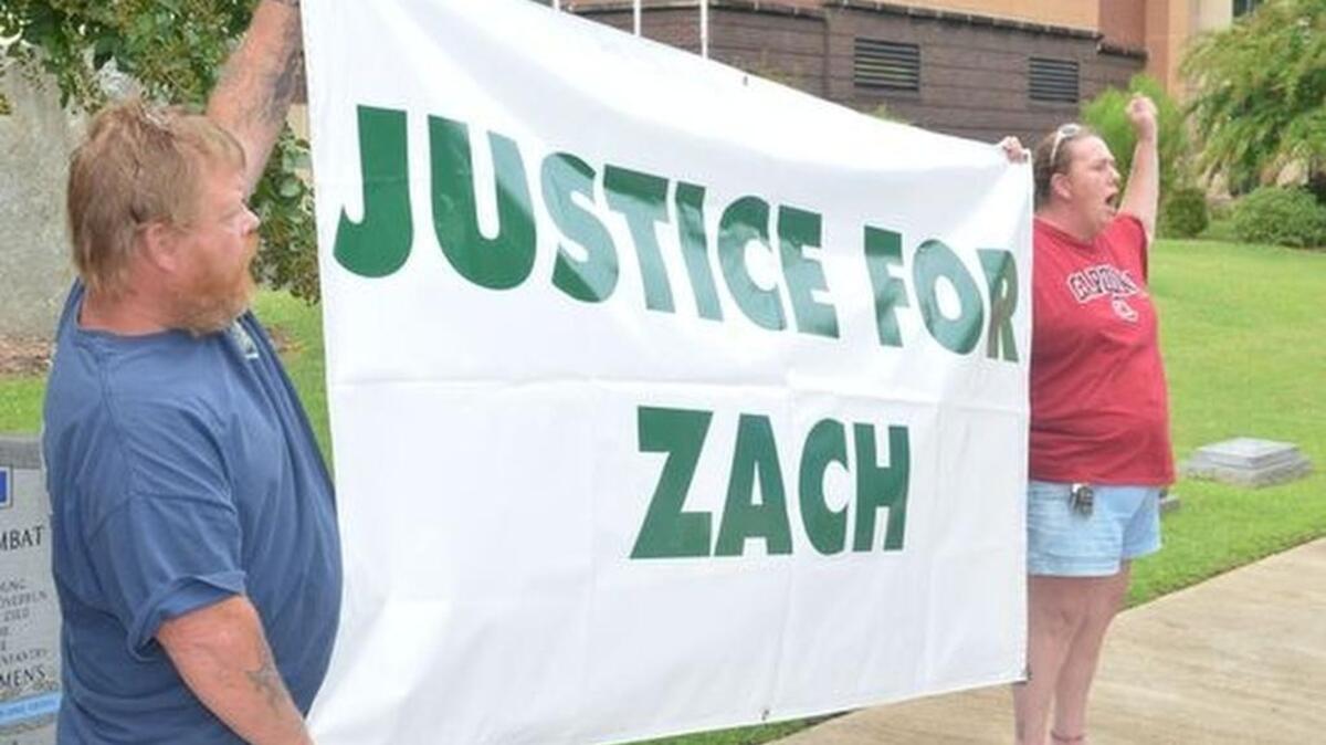 
Supporters of the Zach Hammond family shout for justice during an August rally.
