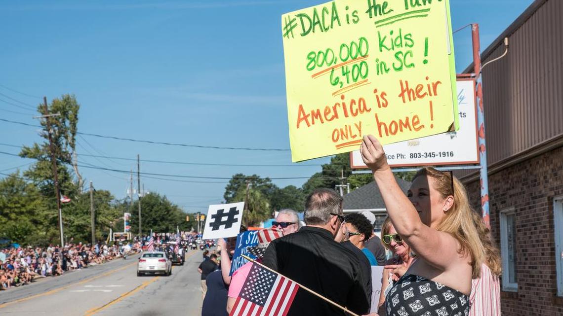 Supporters of DACA (Deferred Action for Childhood Arrivals) await the arrival of South Carolina politicians participating in the Chapin Labor Day parade. They jeered S.C. Attorney General Alan Wilson for his threat to sue the federal government if it doesn’t stop the DACA program.