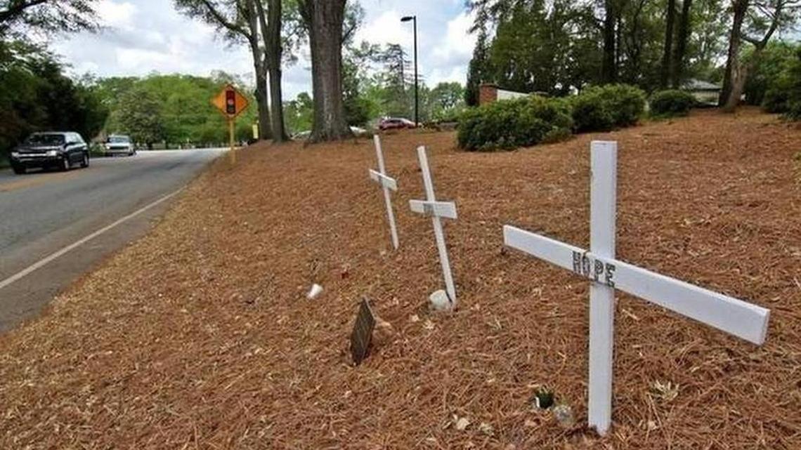 Crosses in remembrance of Amber Hope Perkins, Jessica Ann Roberts, and Corey Austin Simmonds stand in front of Anderson University dormitories in Anderson in April. The three were killed in an auto accident in 2014. A former Anderson University baseball coach, Riley Christopher McDermott, was sentenced to 18 years in prison after pleading guilty in April.