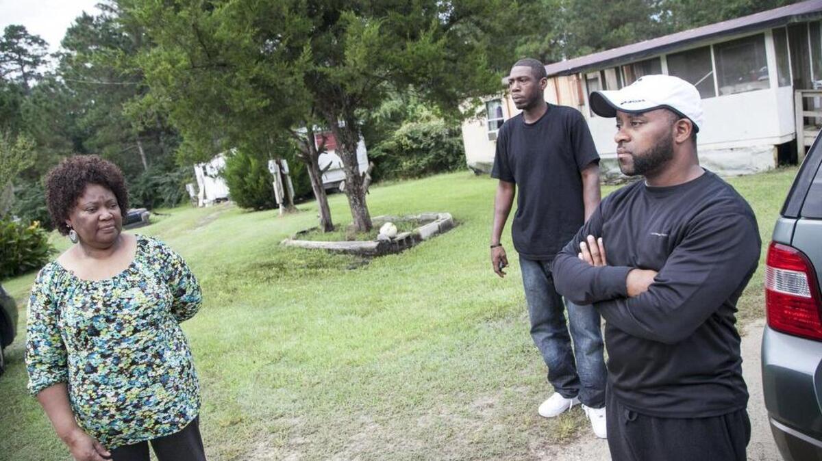 Neighbors look on as media respond to police reports of multiple deaths – possibly a murder-suicide – in a home off Martin Luther Drive in the Bucksport area. Found inside the home were the bodies of a man, a woman and a 10-month old child. A 2-year-old was found alive and taken to a hospital.