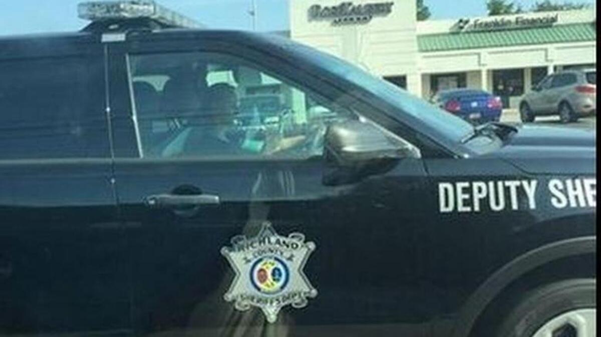 
A photo, reported to have been taken Aug. 10, 2015, on Knox Abbot Drive in Columbia, shows a Richland County deputy who appears to be looking at her phone while driving. The photo has been posted to Facebook and likely will lead to disciplinary action, according to Richland County Sheriff Leon Lott.
