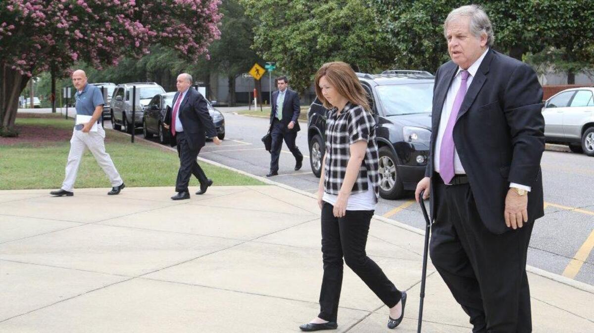 Defense Attorney Jack Swerling arrives at courthouse last August with client Rose Mulholland, who has agreed to plead guilty in Irish Traveler case.