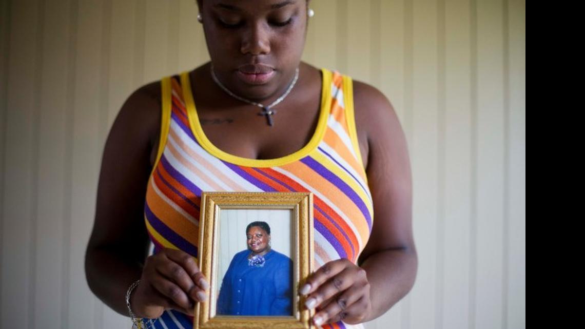 
Najee Washington holds a photo of her grandmother Ethel Lance, one of the nine people killed in Wednesday's shooting at Emanuel AME Church
