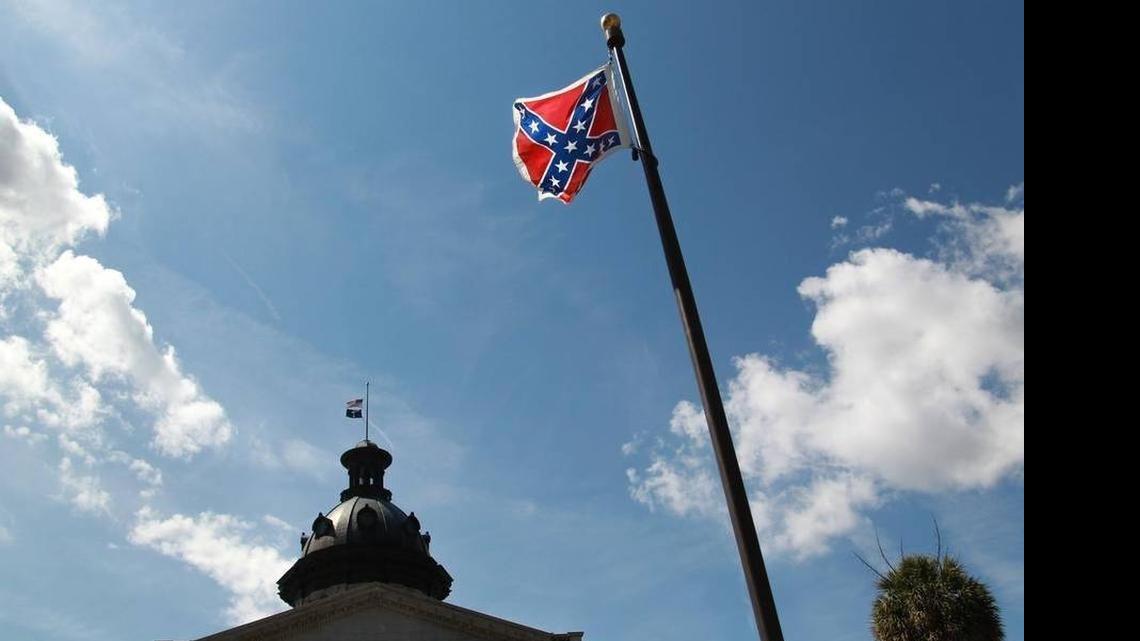 
The Confederate flag flies next to a Confederate Soldier Monument on the grounds of the S.C. State House. Melissa High of North Carolina was arrested July 3, 2015, after she vaulted the fence surrounding the monument and flag. She carried a large poster board with biblical references and the Pledge of Allegiance, according to a news release. Authorities say they also found a knife with a 15-inch blade in a bag High was carrying.
