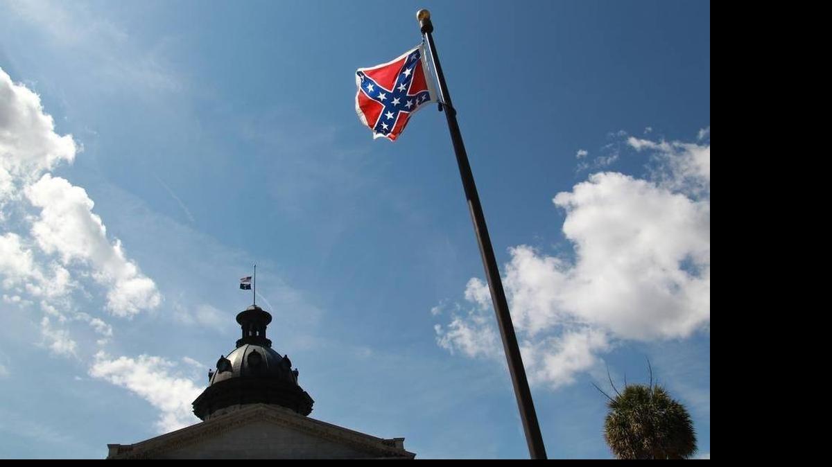 
The Confederate flag flies next to a Confederate Soldier Monument on the grounds of the S.C. State House. Melissa High of North Carolina was arrested July 3, 2015, after she vaulted the fence surrounding the monument and flag. She carried a large poster board with biblical references and the Pledge of Allegiance, according to a news release. Authorities say they also found a knife with a 15-inch blade in a bag High was carrying.
