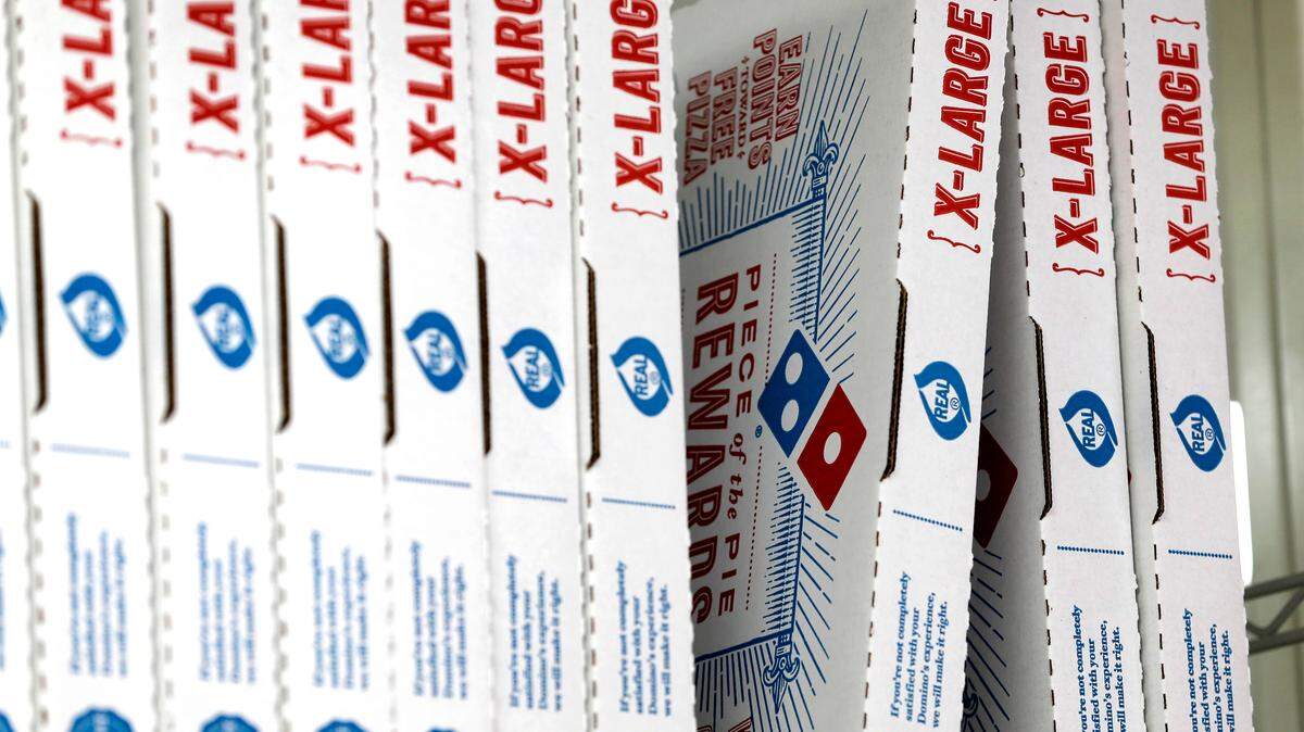 FILE- This Oct. 27, 2016, photo shows Domino’s Pizza boxes at one their locations in Florida. (AP Photo/Alan Diaz, File)