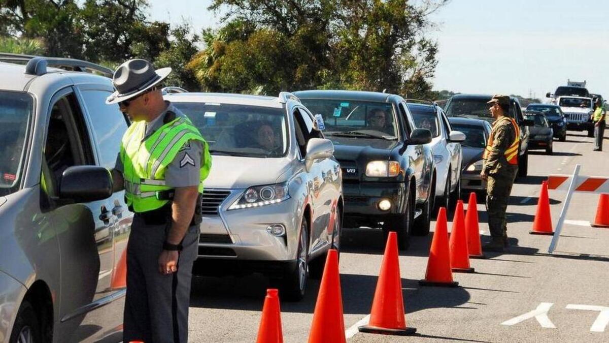 Cars line up at a checkpoint.