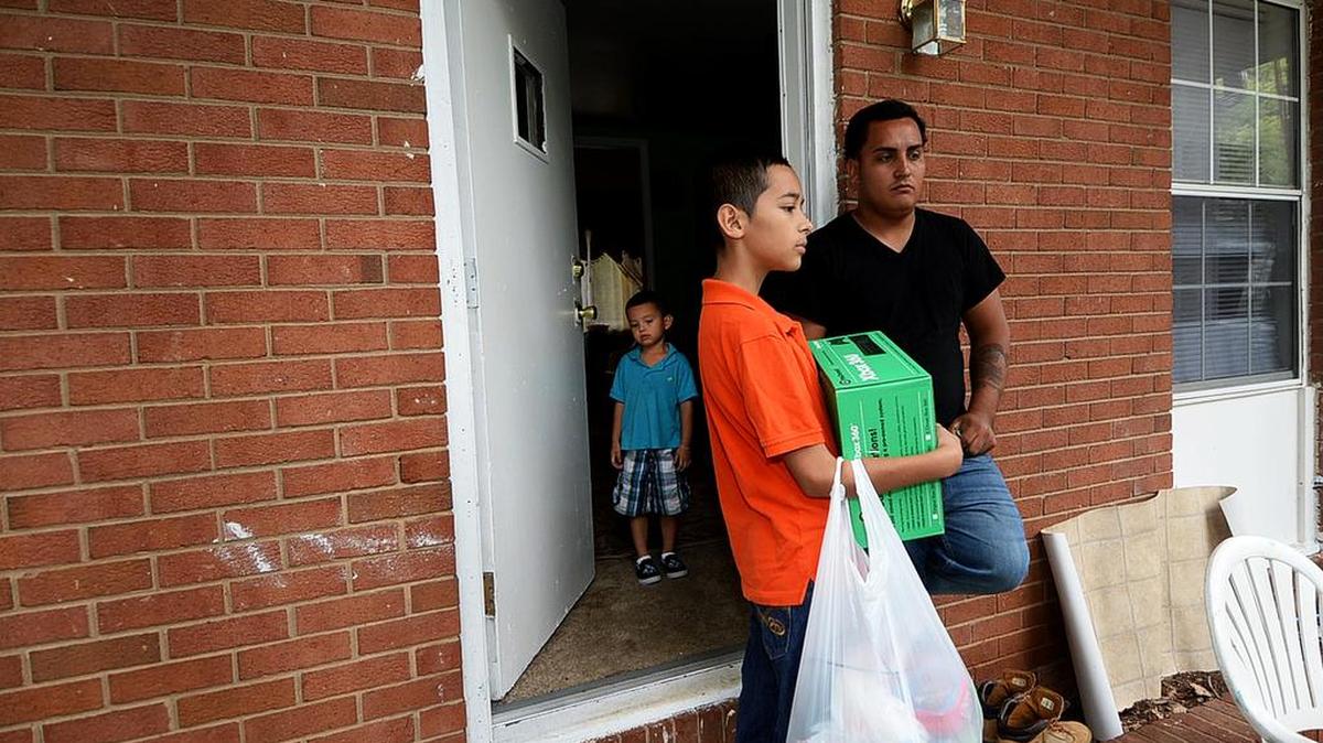 
Jose Gomez Rodas, right, uncle of shooting victim Kevin Antonio Calderon Rodas, 7, with Jonathan Masa Rodas, 3, far left, and and Cristian Rodas, 11, both cousins of the shooting victim, as Cristian Rodas and Jose Rodas talk at the scene of the shooting at 6824 Fieldvale Place, where family members were packing up and moving out on Monday.
