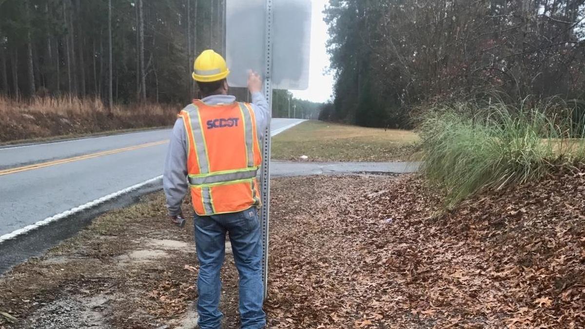 Lexington Maintenance’s Ed Schumpert is shown covering graffiti on one of the vandalized signs. The second vandalized sign was replaced Wednesday morning.