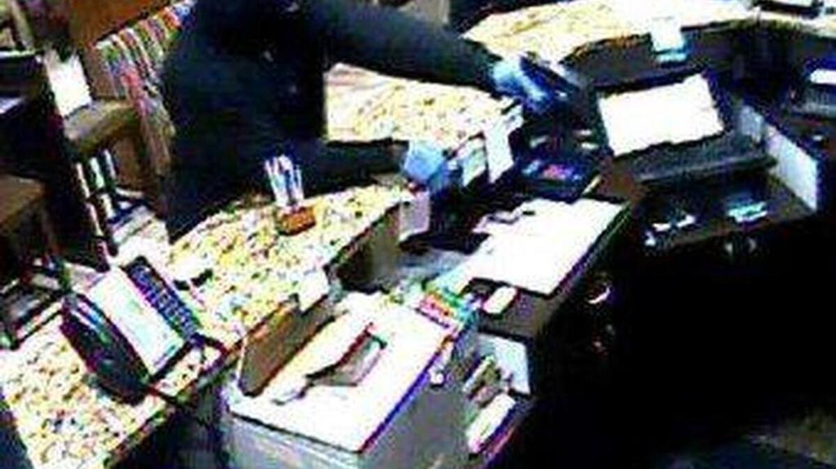 Surveillance cameras capture images of suspects of an armed robbery at a Microtel.