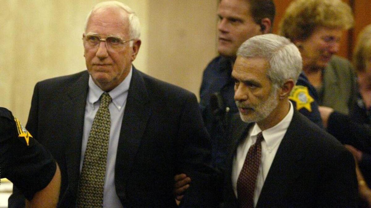 Edward Freiburger leaves the courtroom in 2002 with then-attorney, John Delgado, after a jury convicted Freiburger of murder. He was sentenced to life in prison in the 1961 shooting death of Columbia cab driver John Orner.