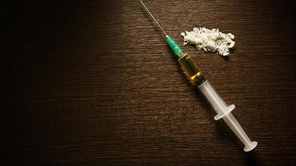 A syringe and cooked heroin