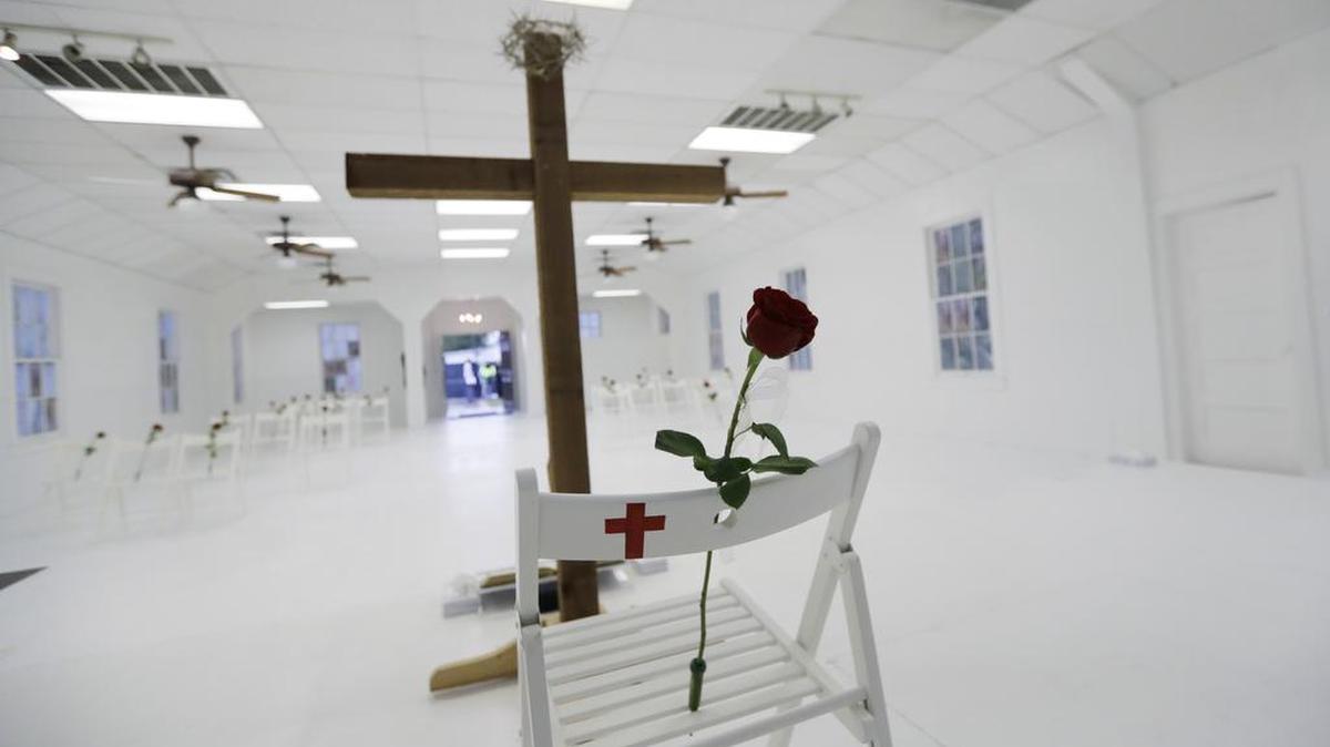 A memorial for the victims of the shooting at Sutherland Springs Baptist Church includes 26 white chairs, each painted with a cross and and rose, placed in the sanctuary, Sunday, Nov. 12, 2017, in Sutherland Springs, Texas. A man opened fire inside the church in the small South Texas community last week, killing more than two dozen.