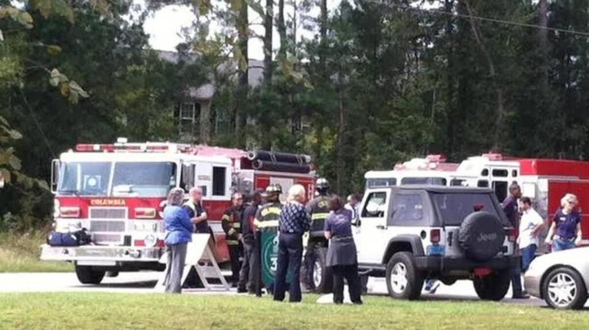 
Emergency responders tend to a state guardsman injured in a hit-and-run accident while directing traffic Friday outside of Harvest Hope Food Bank on Shop Road.

