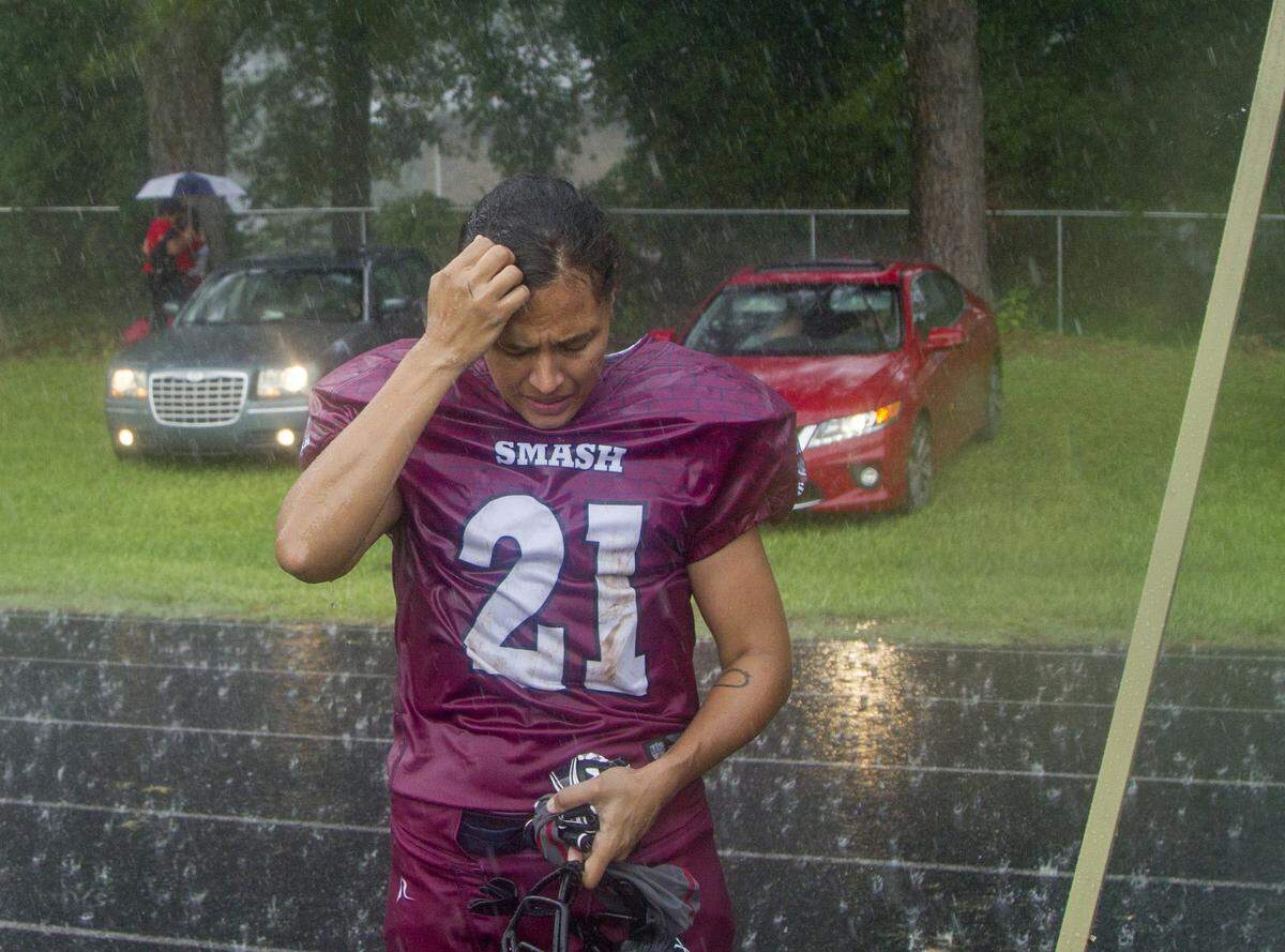 S.C. Smash’s Marie Starkey stands in the rain after losing to the Atlanta Phoenix at Columbia High School in Decatur, Ga. The loss gave the team a 4-4 record and dashed their hopes of making the playoffs.