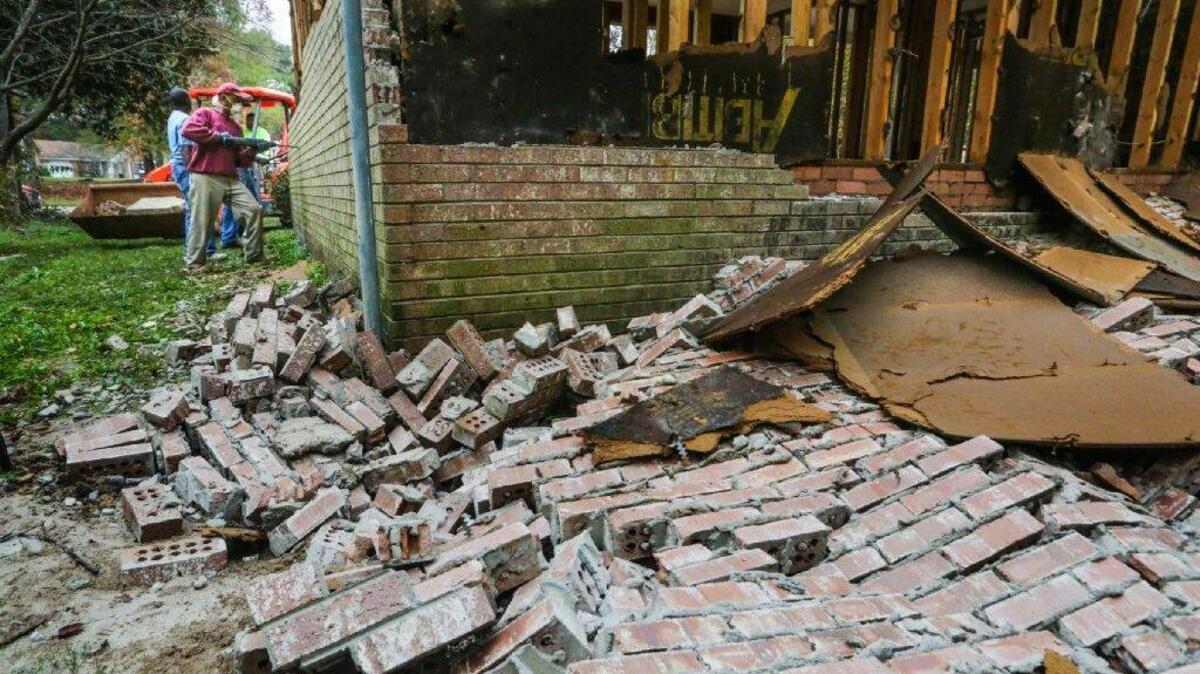 FILE PHOTO: Pine Glen residents are finding out whether they can repair their flood-damaged homes without elevating them. Shafekah Carter was approved and had started repairs when the contractor found mold under the house and on the exterior surfaces behind the brick.