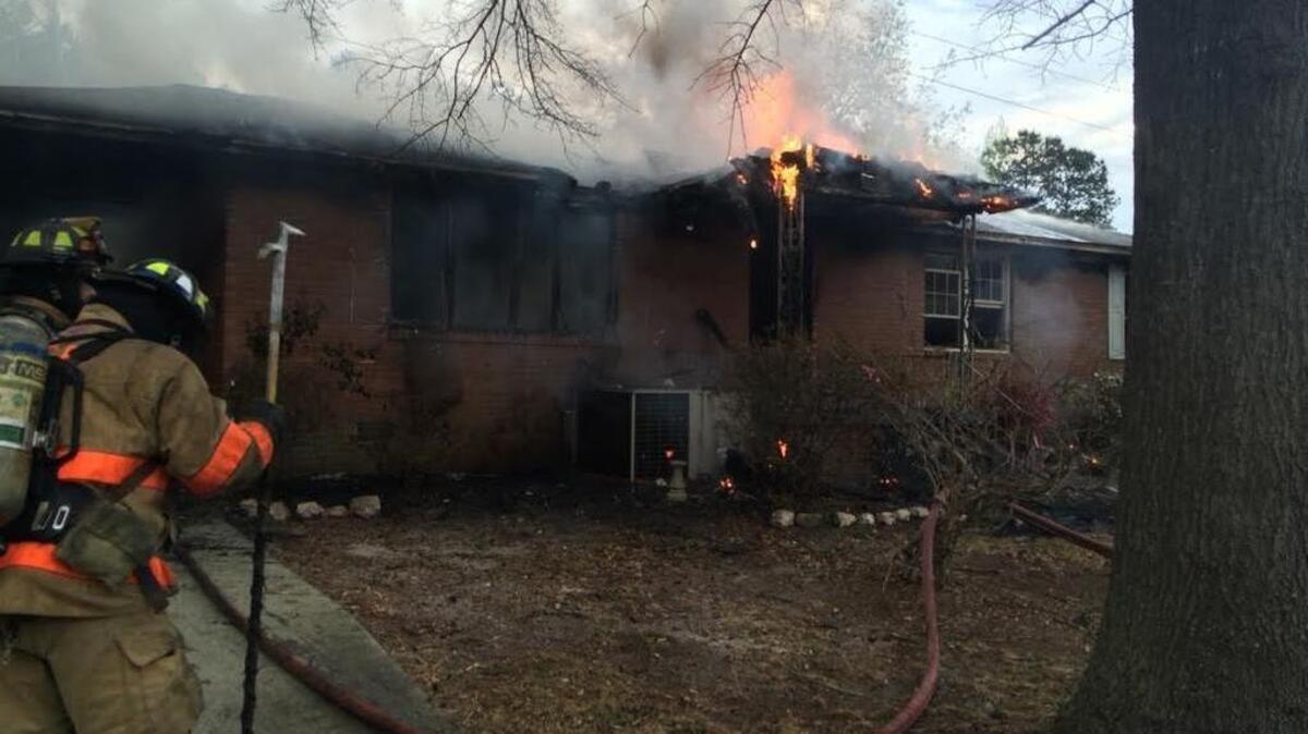 Firefighters at the scene of a fatal house fire in Springdale Saturday morning.